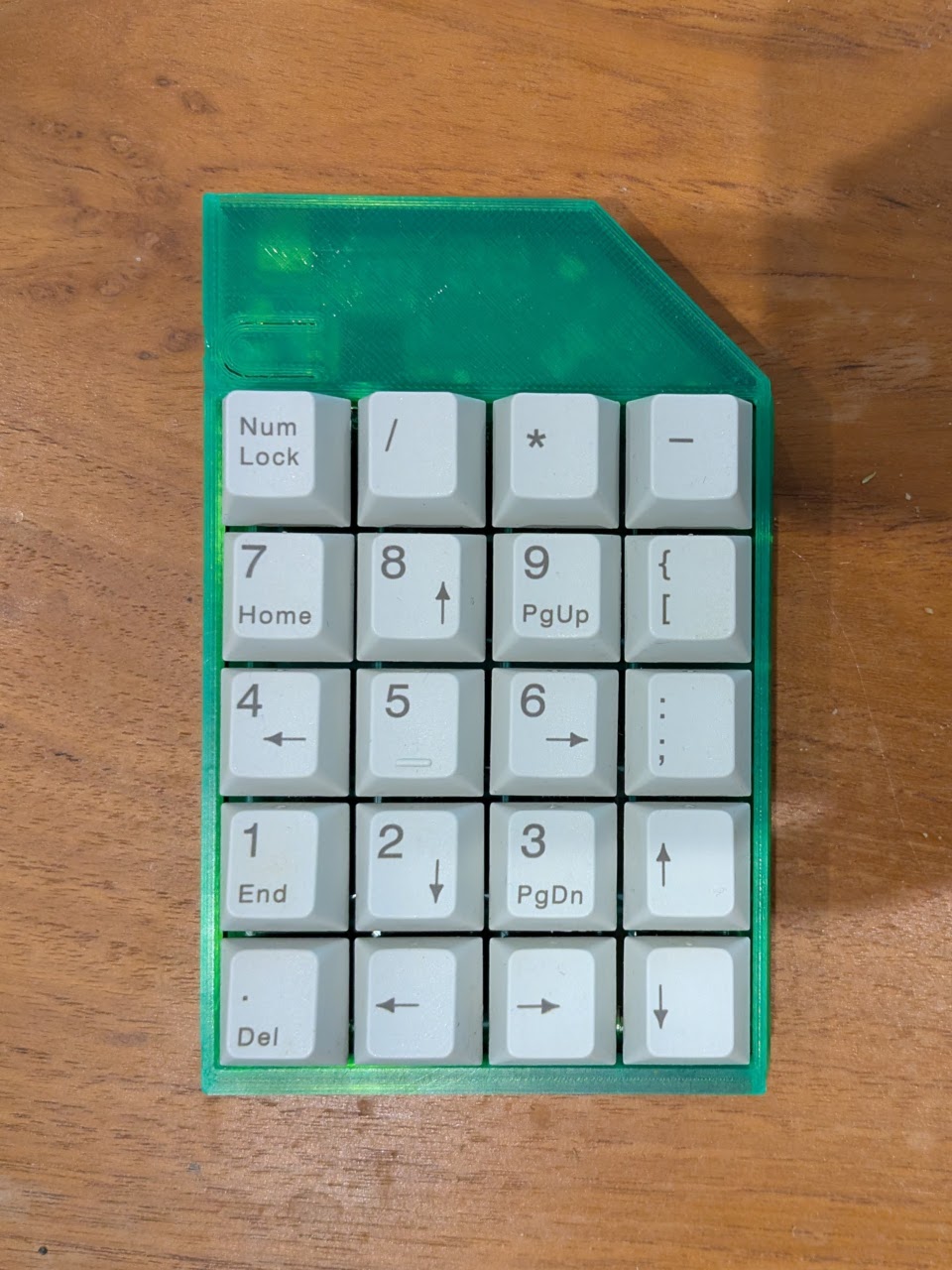 Top-down view of a TwentyPad in a 3D printed case of translucent green filament