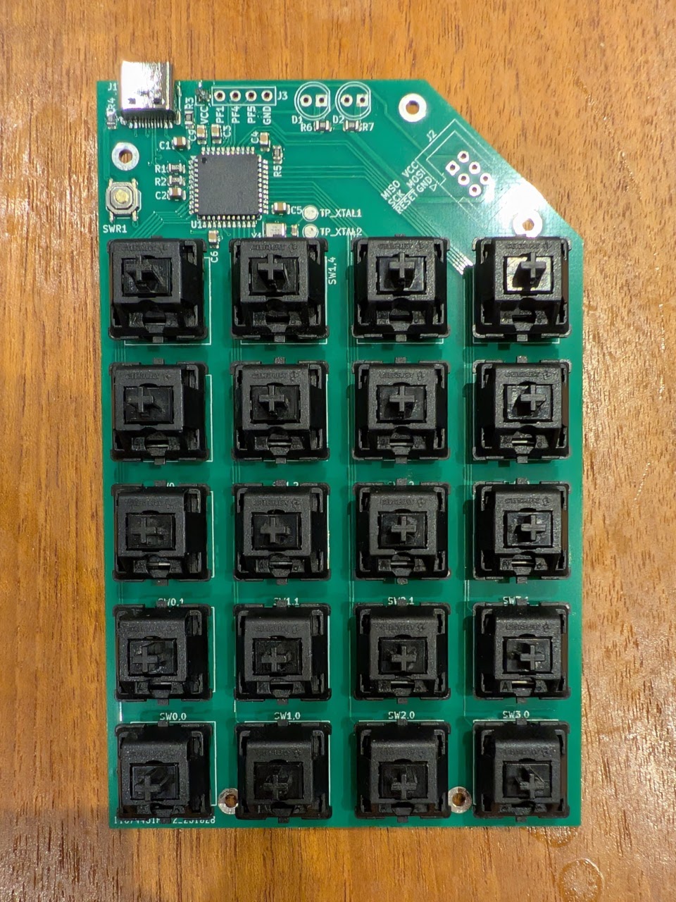 Photo of a TwentyPad PCB with black Cherry keyboard switches soldered on